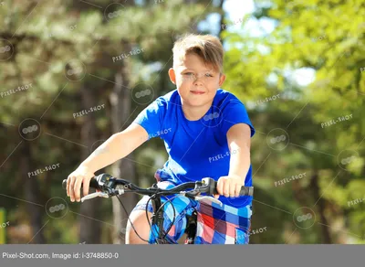 Мальчик катается на велосипеде по улице | Премиум Фото