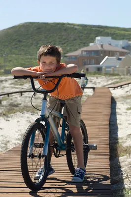Маленький мальчик на велосипеде в городском парке | Премиум Фото
