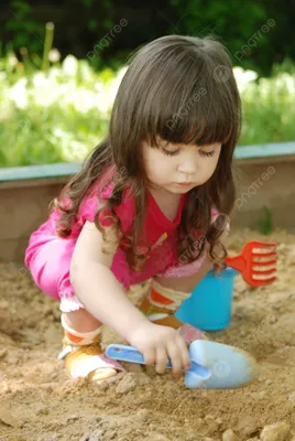 Two girls play in the sandbox Stock Photo by ©oksixx 49992763