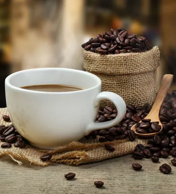 Чашка кофе с кофейными зернами на бежевом фоне стоковое фото ©belchonock  32501631