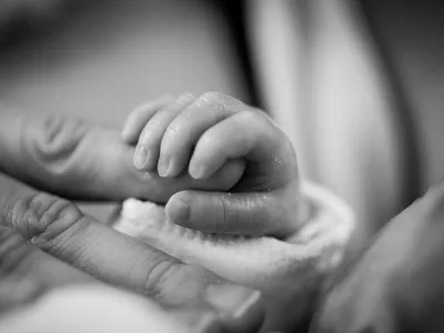 Рука младенца на руке мамы